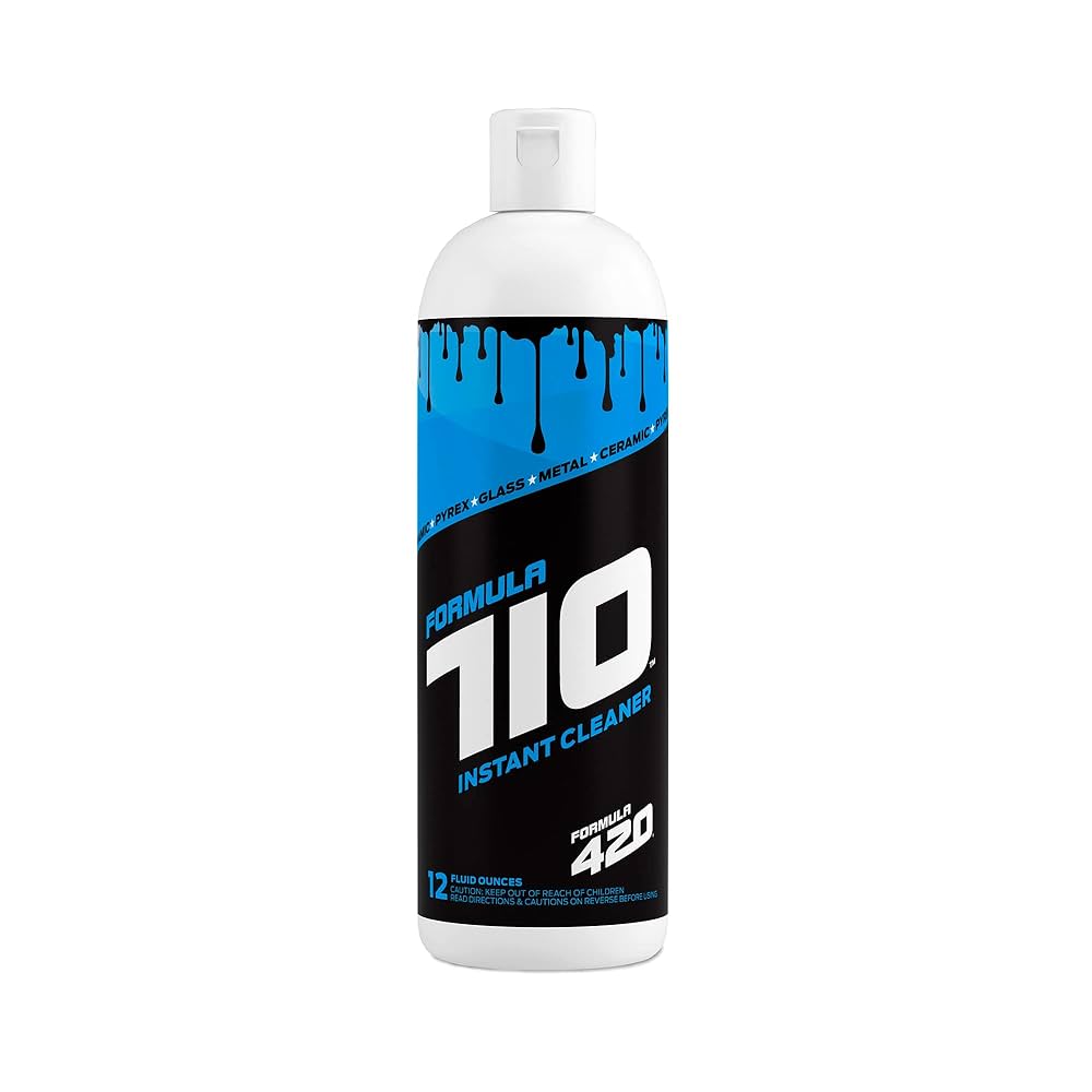 Front view of the Formula 710 Instant Cleaner C2 Wash bottle in clear plastic with a vibrant blue and black label. Featuring patented AbrasivAction technology, this powerful solution uses scrubbing crystals to instantly remove sticky wax and oil buildup from glass concentrate rigs without the need for soaking.
