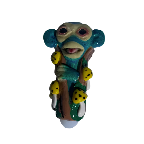 Front view of the 5-inch Glizzy Ceramic Monkey Mushroom Pipe featuring a brown monkey sitting on a red and white spotted mushroom. This novelty hand pipe utilizes a high-density fired clay construction that serves as a rigid, heat-resistant barrier to actively dissipate thermal exhaust.