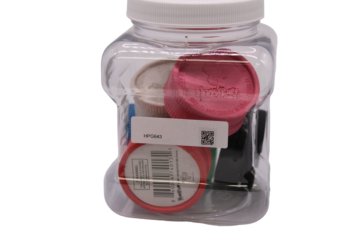 Front view of the Honeypuff 43mm hemp grinder 6-count display jar holding assorted colors. This eco-friendly, retail-ready bulk jar is perfect for smoke shop checkout counters and provides customers with a highly portable, biodegradable dry herb grinder.