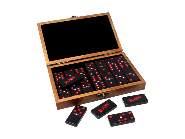 Angled overhead view of the RAW double six dominoes set inside its open natural wood box. The 28 individually crafted dominoes fit perfectly into the protective wooden case for easy travel and organized storage.