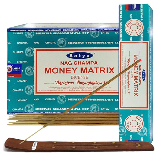Front view of the Satya Incense 15g 12-Count Display box in the Money Matrix variant featuring metallic gold typography. This combustible agarbatti stick display unit is ideal for vertical counter placement to drive impulse checkout transactions.