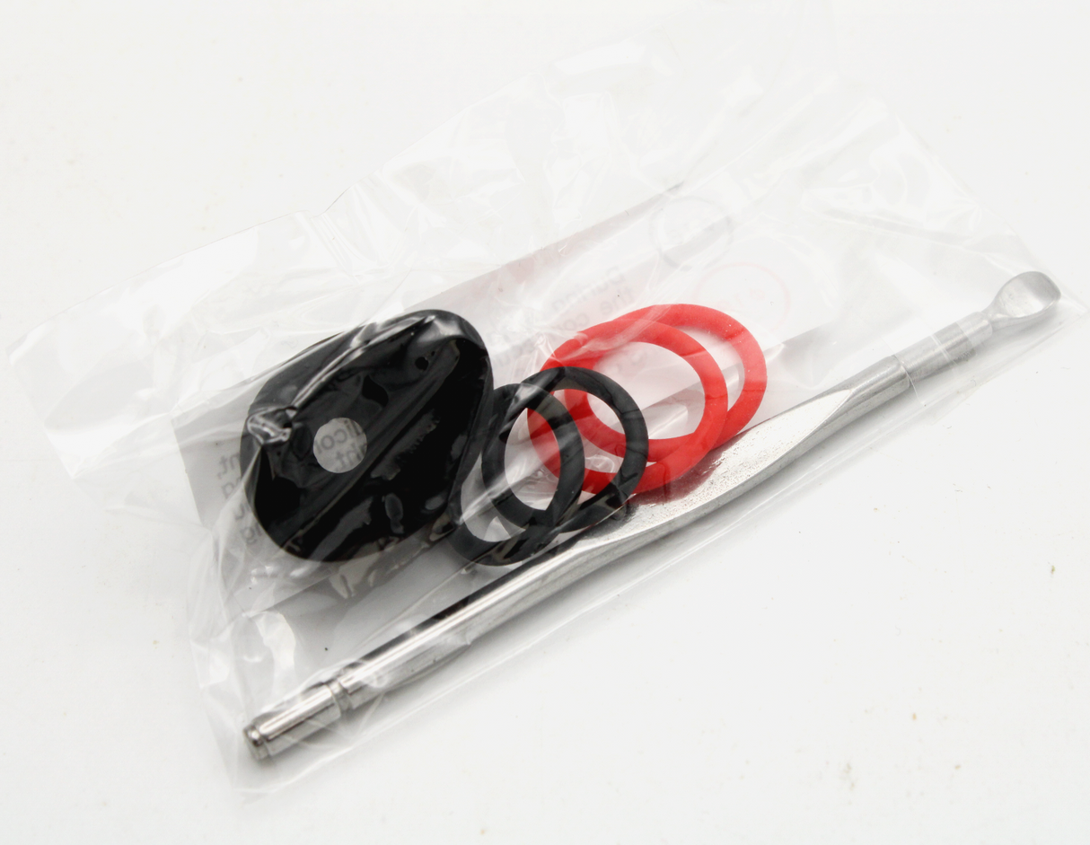 view of the replacement parts and dab tool contained in the Exxus VRS 3 in 1 vaporizer kit.