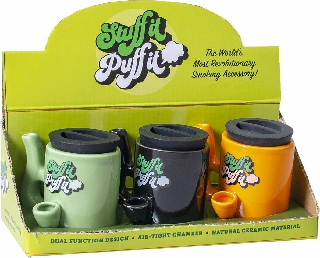 front view of the stuff it puff it display box. A multi use mug with pipe and stash jar for storage.