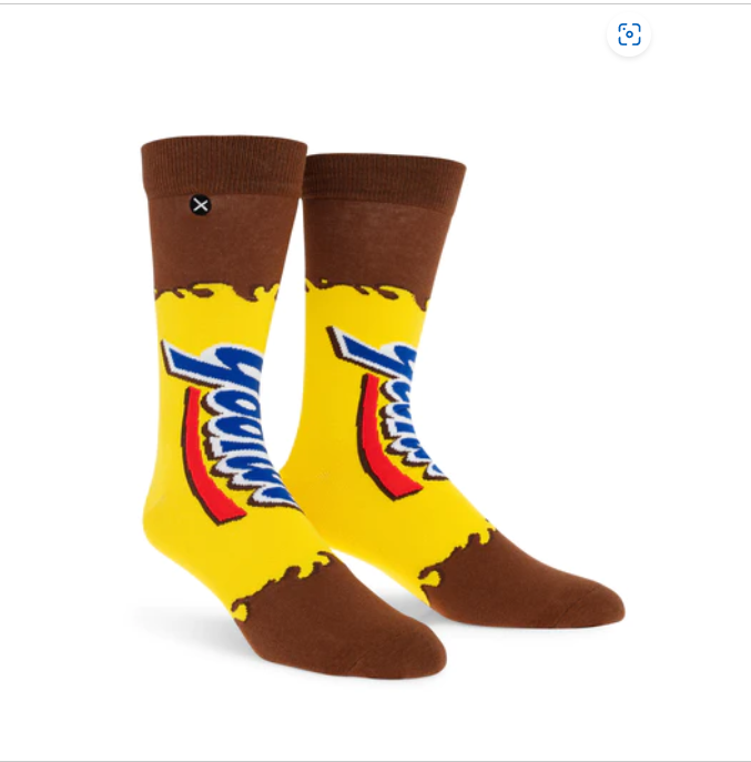 Front view of a pair of Crazy Socks featuring officially licensed Yoo-hoo Chocolate Drink graphics. These vibrant novelty crew socks showcase the classic yellow and blue brand logo text layered over a bright yellow and brown background to add a distinct pop to your outfit.