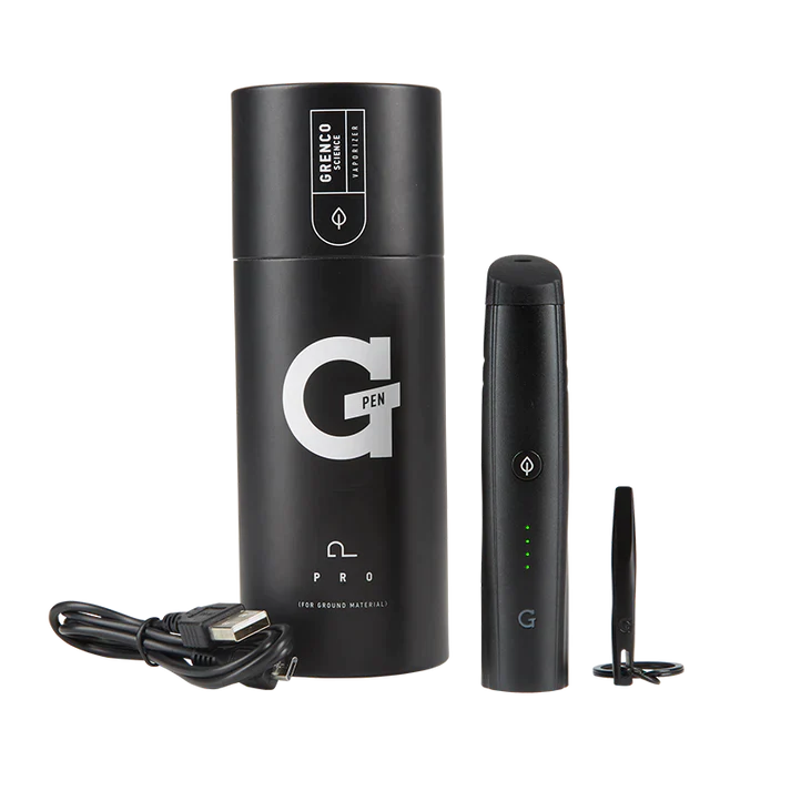 Overhead spread view of the G Pen Pro Dry Herb Vaporizer Kit in black, arranged alongside its included accessories. The complete kit includes the vaporizer, a USB charging cable, cleaning brush, packing tool, and a signature G-card grinder for ultimate convenience.