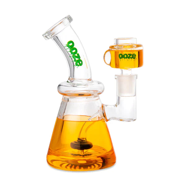 Front view of the Ooze Glyco Glycerin Freezable Water Pipe in juicy orange. This compact 6.5-inch borosilicate glass beaker bong features a hollow base filled with bright green freezable liquid glycerin to deliver incredibly cold, ice-like hits.
