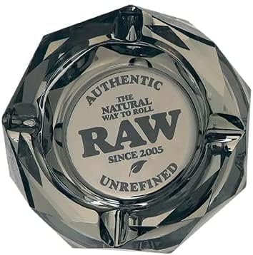 Angled top-down view of the RAW Dark Side Geometric Glass Ashtray showcasing its multi-faceted crystalline shape. This heavy-duty prismatic glass ashtray features a deep obsidian black finish and includes the iconic red RAW logo centered in the ash basin.