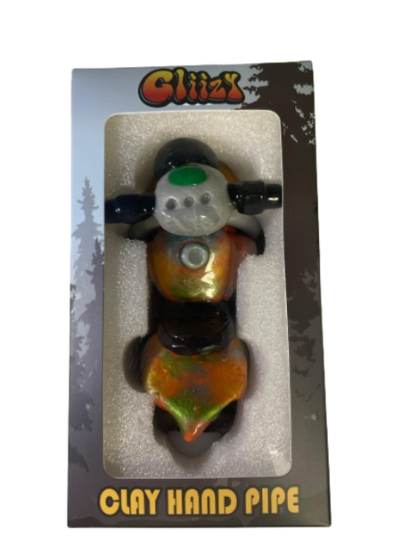 Angled profile view of the 5" Glizzy Clay Hand Pipe with a red accent. This novelty food-themed clay smoking instrument is designed to visually replicate a hot dog, featuring an integrated deep-dish bowl and side-carb.