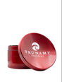 Side view of the Tsunami premium grinder showcasing its concave top assisting with moving your herb to be broken down consistently and made of durable metal with a chromium finish in a deep red.