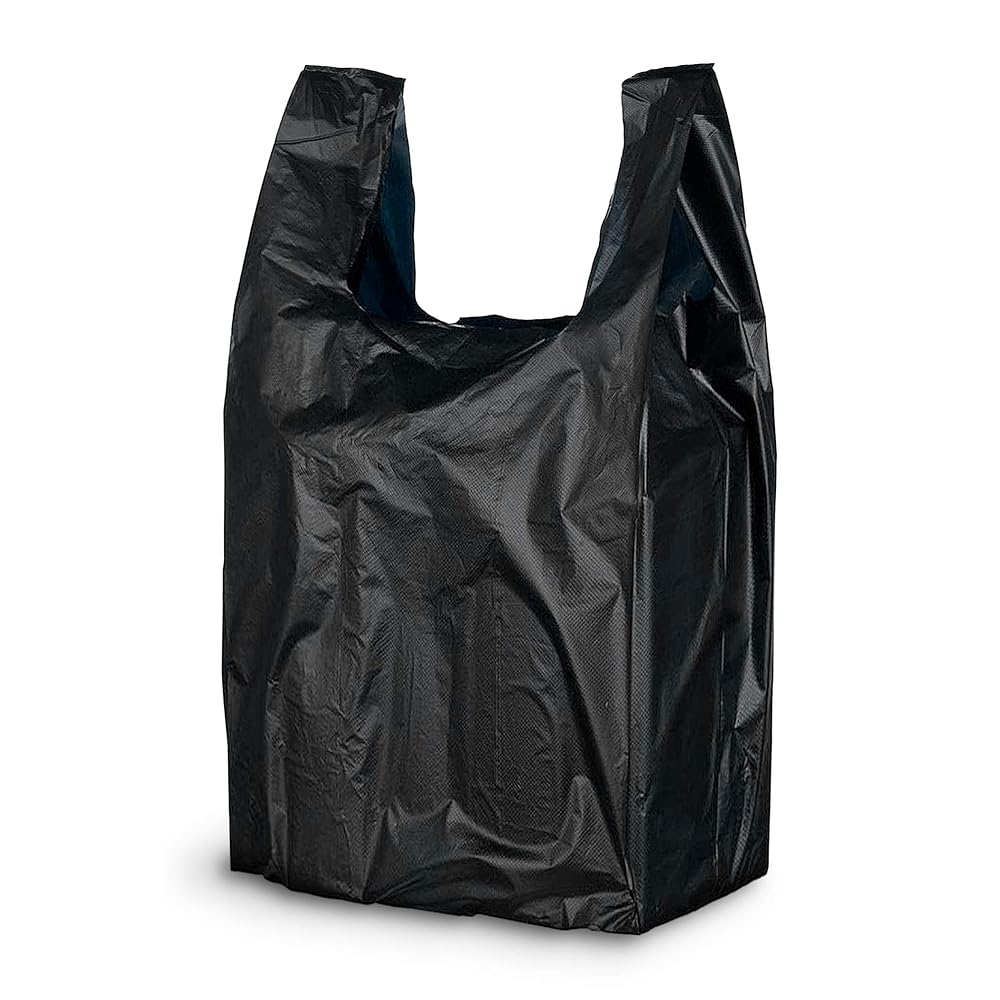 Side profile view of an opened black plastic t-shirt bag hanging by its dual handles to showcase the expandable side gussets. This strong, tear-resistant bag expands laterally to easily accommodate bulky grocery items or multiple heavy retail goods without ripping.