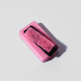 Front view of the Blazy Susan Magnetic Resin Blaster Scrubber components in pink and black. This dual-magnetic architecture pairs an external control handle with an internal scrubbing unit to mechanically scrape tar from hard-to-reac