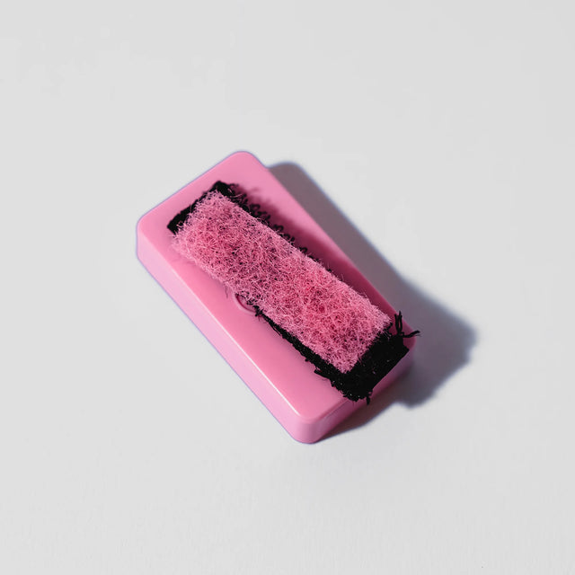 Front view of the Blazy Susan Magnetic Resin Blaster Scrubber components in pink and black. This dual-magnetic architecture pairs an external control handle with an internal scrubbing unit to mechanically scrape tar from hard-to-reac