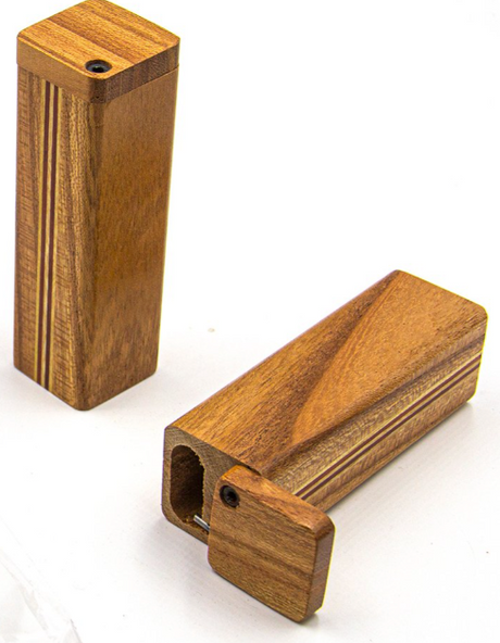 Top-down view of an open wooden square dugout in a light cherry wood finish. This image showcases the dual internal storage chambers, including a storage compartment for herbal blends and a separate spring-loaded slot for the pipe bat.