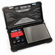 Top down view of the MyWeigh Triton T3 Rechargeable Scale in black with its cover open. This pocket-sized 500g unit features a shock-absorbing rubberized casing and an integrated lithium-ion battery for reliable, cord-free measuring.