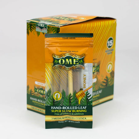 Front view of the closed OME hand rolled tendu leaf wraps 15-count display box in bright golden orange. This wholesale retail display provides shops with premium, tobacco-free pre-rolled palm leaf wraps for a smooth and slow-burning smoke.
