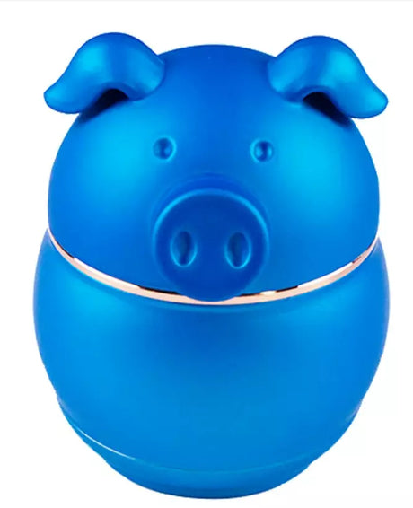 Front angled view of the 62mm piggy shape metal grinder in metallic blue. This 4-piece novelty swine-themed unit features a magnetized top enclosure to manually process unrefined botanical materials.