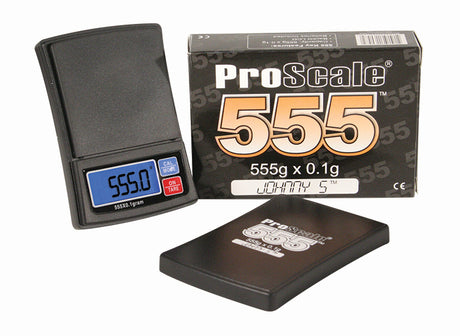 Angled overhead view of the Pro Scale Johnny 5 digital pocket scale in black and silver. This reliable 555g x 0.1g scale features a durable, compact construction for professionals who need precise measurements on the go.