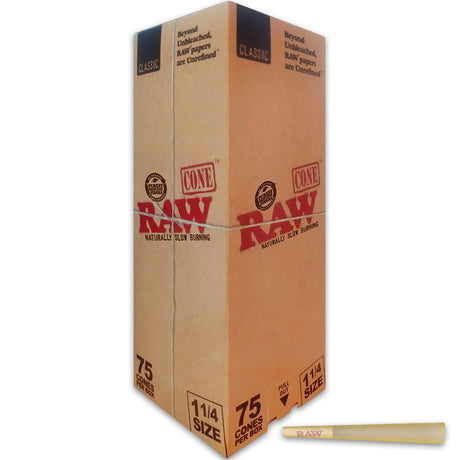 Front angled view of the RAW 1 1/4 Pre-Rolled Cones 75-count retail box in signature unbleached tan brown and red. This wholesale paper container stores 75 pre-rolled plant fiber cones neatly for personal stock or direct dispensary retail shelves.