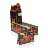 Front angled view of the RAW Classic Black Single Wide Papers 25-count display box in sleek black packaging with gold and red branding. This retail-ready carton provides smoke shops with an attractive countertop presentation for these premium ultra-thin rolling papers.