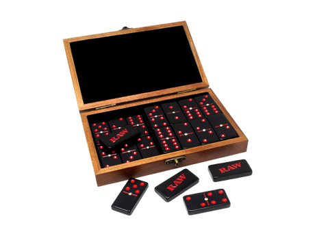 Angled overhead view of the RAW double six dominoes set inside its open natural wood box. The 28 individually crafted dominoes fit perfectly into the protective wooden case for easy travel and organized storage.