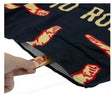 Close-up view of the RAW Stash Pocket Beach Towel in black and red, highlighting the concealed compartment. This 100% cotton large-format fabric features an integrated Velcro-sealed stash pocket to safely conceal smoking hardware and unrefined materials from the elements.