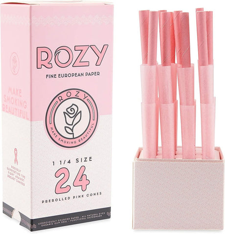 Front view of the Rozy Pink Cones 1 1/4 size 24-count wholesale retail display box opened to showcase the individual three-packs. This open countertop-ready carton is engineered to drive high-volume checkout additions of pre-rolled pink paper cones.