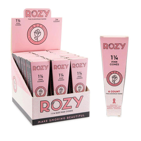 Front angled view of the Rozy Pink Pre-Rolled Cones 1 1/4 Size 24-count display carton in a vibrant pink. These mechanically dyed European paper wraps hold approximately 0.75 grams of unrefined botanical material and feature a pre-installed W-style filter tip.