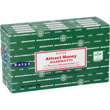Front view of the Satya Incense 15g 12-Count Display box in the Attract Money variant featuring yellow and green accents. This combustible agarbatti stick display unit is ideal for vertical counter placement to drive impulse checkout transactions.