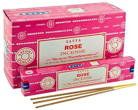 Front view of the Satya Incense 15g 12-Count Display box in the classic Rose variant featuring pink petal graphics. This combustible agarbatti stick display unit is ideal for vertical counter placement to drive impulse checkout transactions.