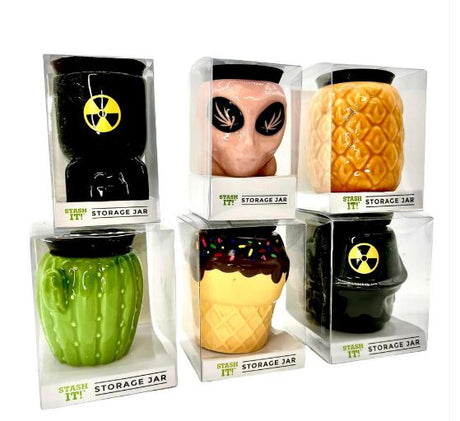 Front view of multiple Stash-It 3oz Storage Jars in an assortment of vibrant novelty designs. These compact stash jars feature a durable build and an airtight silicone lid to keep your herbs, spices, and small valuables perfectly fresh and secure.