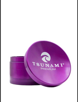 Angled overhead view of the Tsunami 75mm Concave Top Herb Grinder in purple. This oversized 4-piece dry herb grinder features a built-in concave mixing bowl on the magnetic lid and sharp diamond teeth for a smooth, even grind.