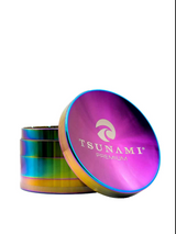 Angled overhead view of the Tsunami 75mm Concave Top Herb Grinder in rainbow. This oversized 4-piece dry herb grinder features a built-in concave mixing bowl on the magnetic lid and sharp diamond teeth for a smooth, even grind.