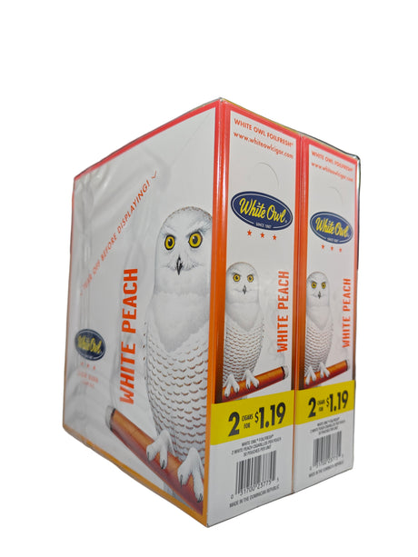 Angled overhead view of the White Owl Slow Burn White Peach cigarillos box in soft peach-orange and white. These popular slow-burning cigarillos come in a wholesale 30-count box of 2-packs, perfect for keeping retail counter displays fully stocked.