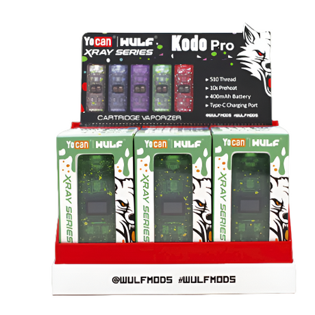 Front angled view of the Yocan Wulf Kodo Pro X-Ray 510 Battery 15-count counter display box showcasing assorted see-through spatter colorways. This compact wholesale box includes an internal cardboard tier setup for immediate retail register placement.