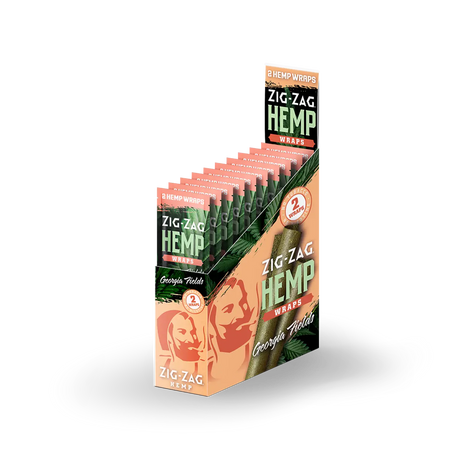 Front angled view of the Zig-Zag Hemp Wraps New Flavors 25-count display box showcasing the bright peach colored retail packaging. These 100% tobacco-free vegan wraps provide a smooth, slow-burning alternative for processing and rolling loose-leaf botanical material.