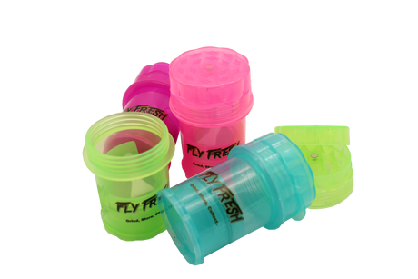view of the Fly fresh grinder with kief catch. A simple herb grinder with removable herb catcher for clean packing.