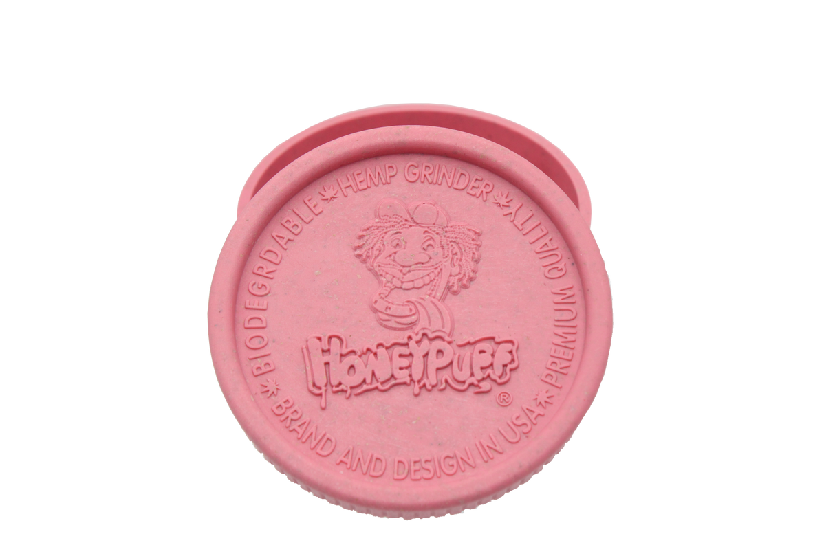 top view of the Honeypuff 56mm Biodegradable pink hemp grinder. A eco friendly grinder that is durable while being compact for everyday use. 