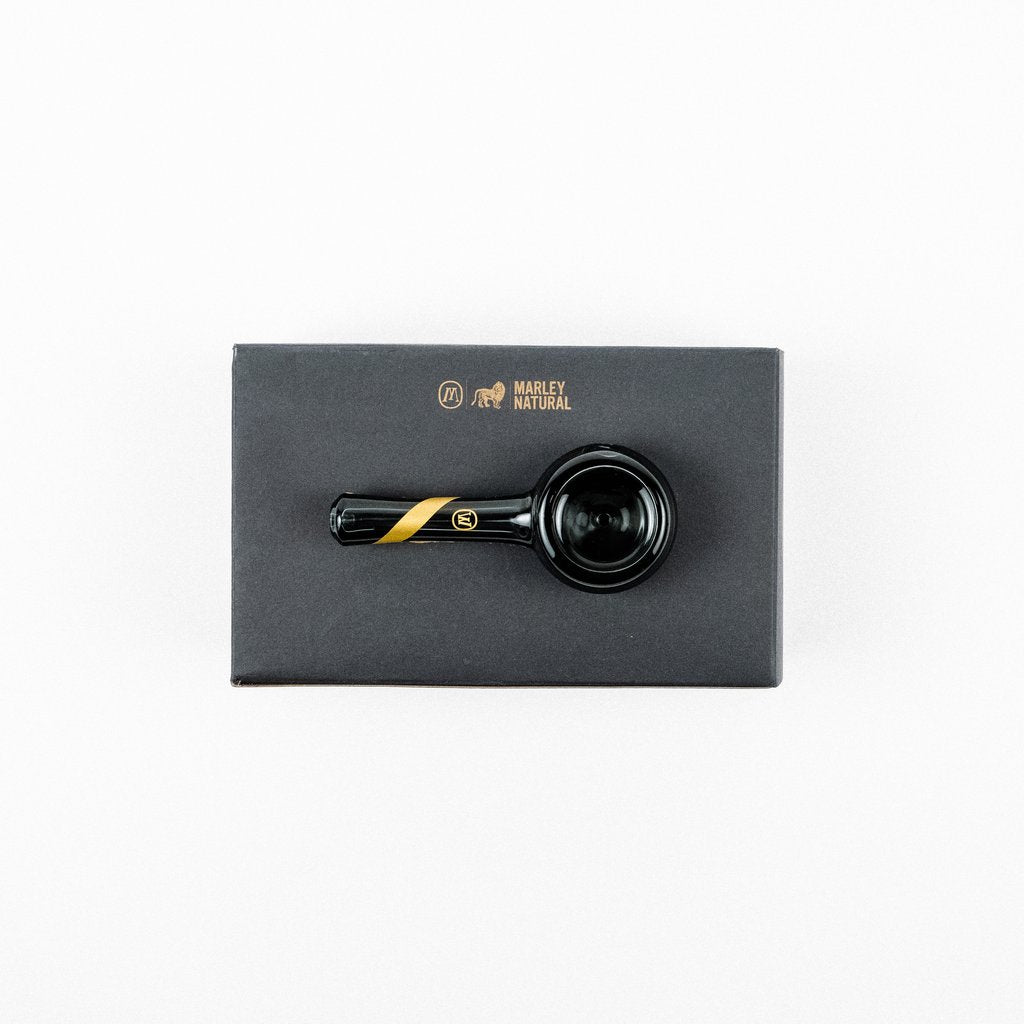 a top down view of the Smoked glass spoon pipe from Marley Natural. A premium smoking pipe made of smoked glass along with its premium feel case.
