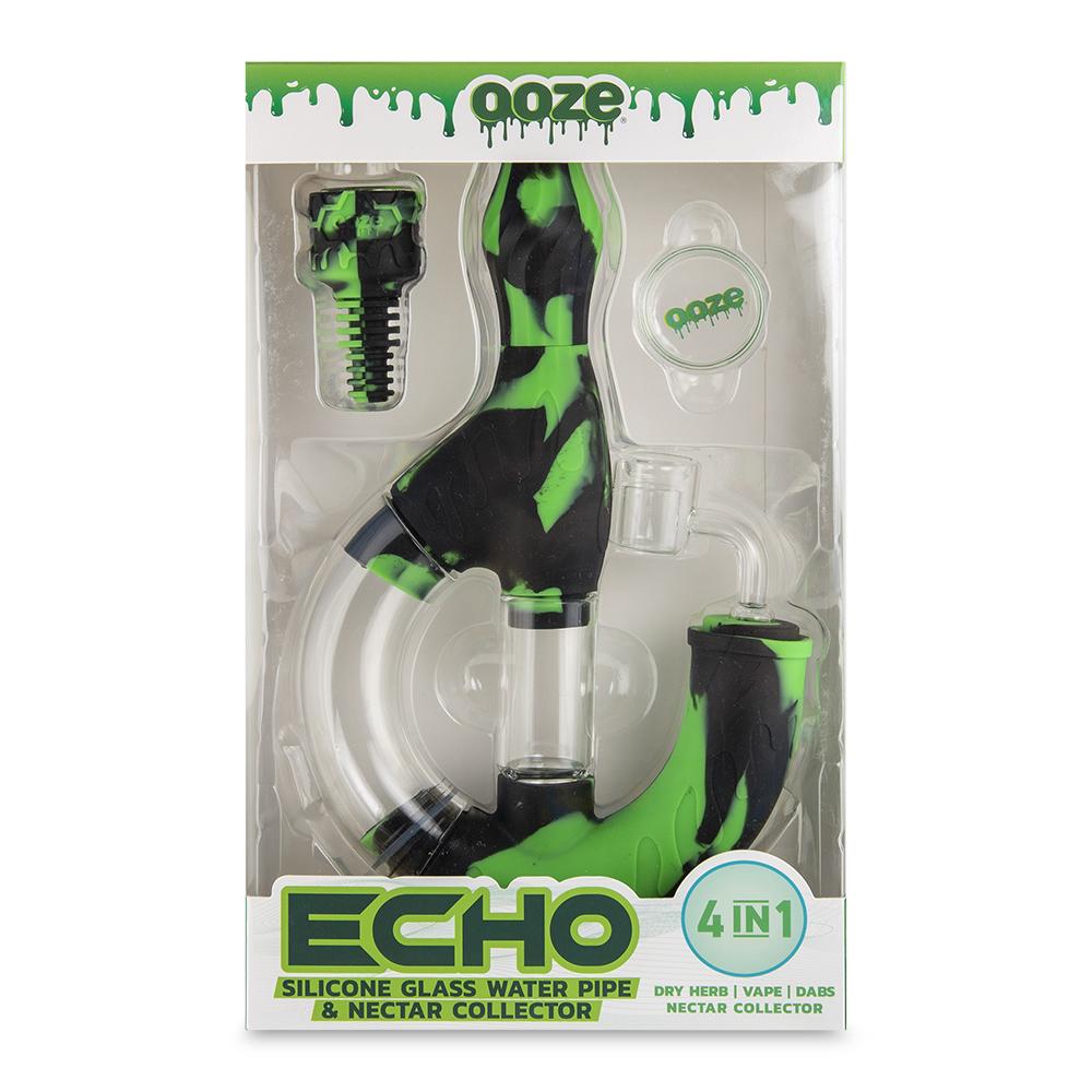 front view of the Ooze Echo silicone water pipe in a green and black pattern in its package. A multi use water pipe able to be used for multiple types of uses. made from durable silicone and high quality glass.