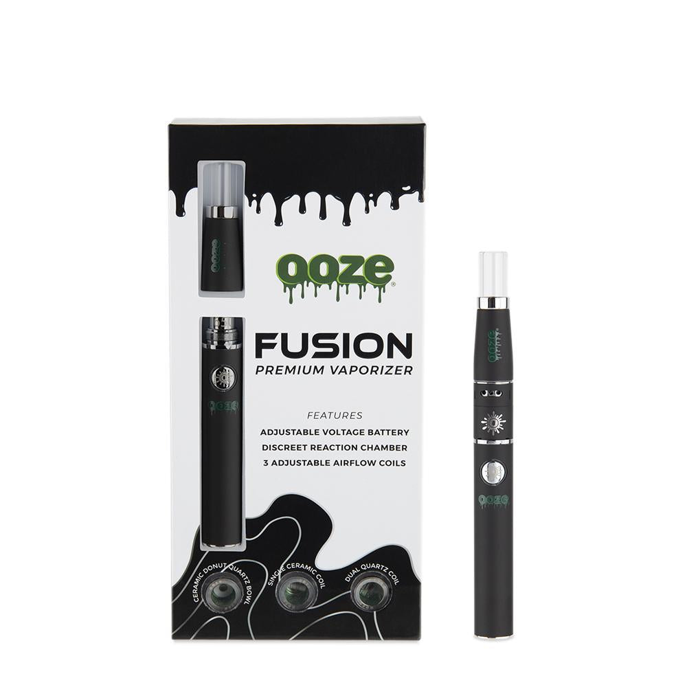 front view of the ooze fusion product and package in a matte black finish. A product built for multiple concentrate experiences with three interchangeable coils for different flavor profiles. and adjustable voltage.