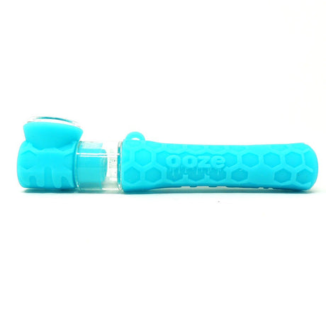 profile view of the Ooze Pipper in a bright teal. A hybrid chillum made from silicone with glass bowl. convenient product for low profile hits.