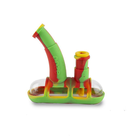 profile view of the ooze steamboat in rasta red, green and yellow, a durable water pipe for both concentrate and dry herb. A premium pipe with the clean flavorless glass with durable silicone.