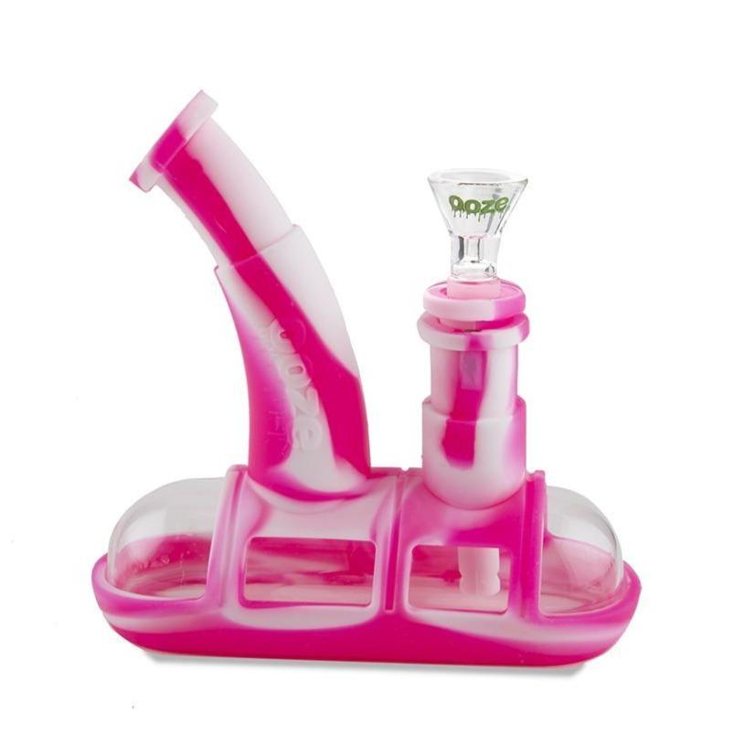 profile view of the ooze steamboat in pink and white, a durable water pipe for both concentrate and dry herb. A popular item with universal compatibility.