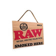 Angled view of the rustic and natural RAW smoked here decor sign.