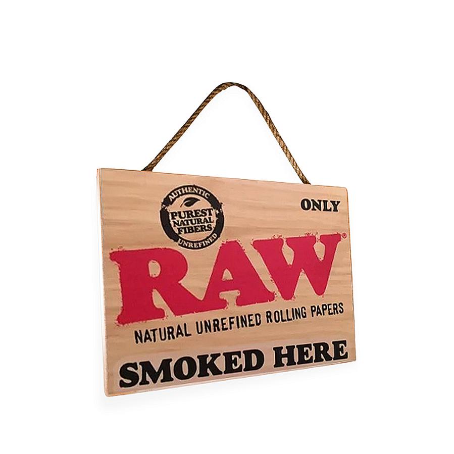Angled view of the rustic and natural RAW smoked here decor sign.