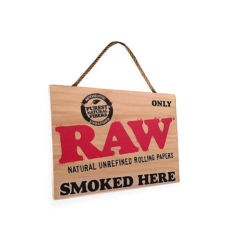 Angled view of the rustic and natural RAW smoked here decor sign.