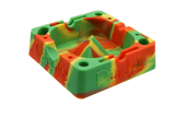 angle view of the Randy's 7" ashtray. A heat resistant and durable ash tray with storage compartments and a debowler spike in the center for ease of cleaning. casted in rasta colors