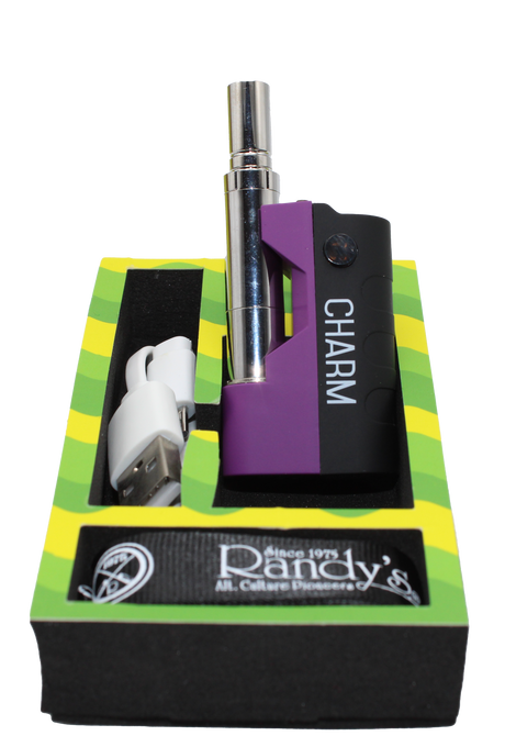 open box view of the Randy's Cham vaporizer made with a durable body, tactile feel, and open panel chassis, along with its charging cable with carrying lanyard.