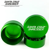 View of the santa cruz shredder in its major pieces in a deep emerald green. Made with medical grade aluminum. Santa Cruz guarantees quality for your rolling experience.