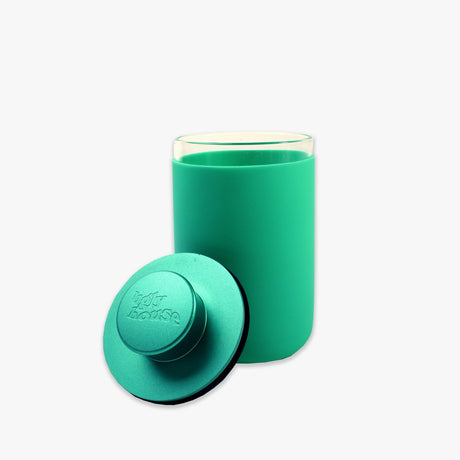 front view of the Ugly house stash air in turquoise. A air sealed storage container made of high quality glass.